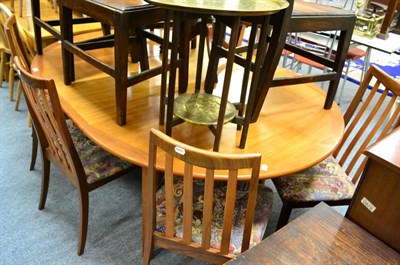 Lot 1103 - A G plan teak extending dining table and six chairs together with a nest of three teak tables and a