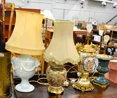 Lot 1114 - Four modern decorative table lamps together with walking sticks, umbrellas and a stick stand