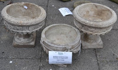 Lot 1133 - A pair of garden urns and similar urn with swag decoration