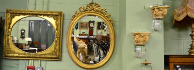 Lot 1208 - An oval ribbon tied mirror together with a reproduction oval mirror in a rectangular frame and...