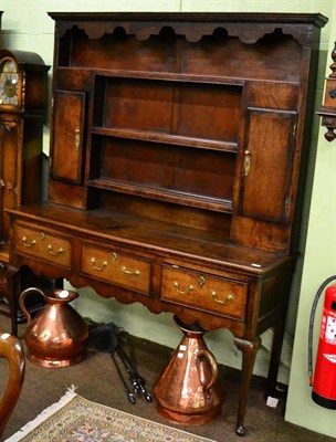 Lot 1217 - A George III oak and mahogany crossbanded dresser and rack, late 18th century, with a shaped...