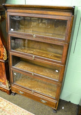 Lot 1229 - An oak sectional bookcase