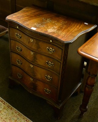 Lot 1236 - A mahogany four height serpentine fronted chest of drawers with dressing slide