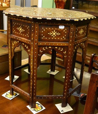 Lot 1240 - A Middle Eastern part ebonised and ivory inlaid mahogany folding occasional table