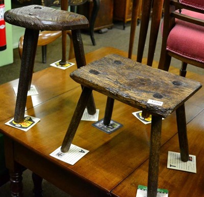 Lot 1250 - A primitive three-legged stool, probably Welsh, Glamorgan, circa 1800, the oak seat with two...