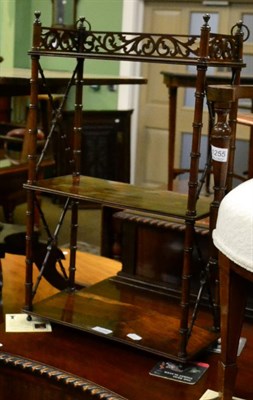 Lot 1256 - A mid 19th century rosewood three tier hanging open bookcase with pierced fret work gallery,...