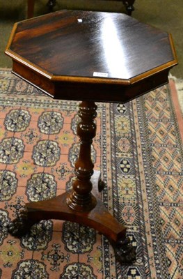 Lot 1264 - A 19th century rosewood work table on triform base and paw feet