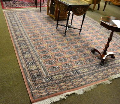 Lot 1286 - A machine made carpet, of Tekke design , the field with columns of quartered guls enclosed by...