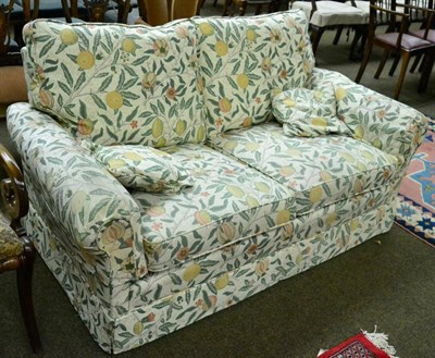 Lot 1293 - A modern two seater sofa, the upholstery decorated with William Morris Pomegranates pattern&nbsp