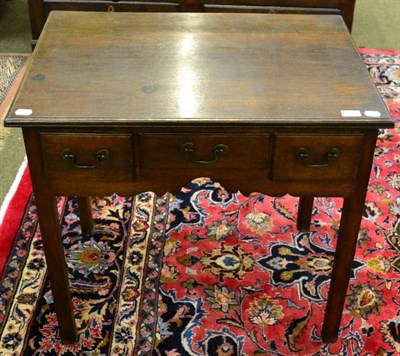 Lot 1304 - A George III oak lowboy, the front fitted with three short drawers, on square supports