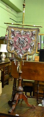 Lot 1307 - A Victorian brass pole screen with beadwork panel