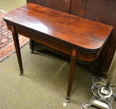 Lot 1327 - An inlaid mahogany fold over tea table