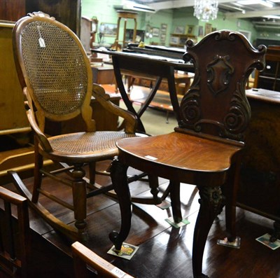 Lot 1335 - A carved mahogany shield back chair together with a bergere rocking chair