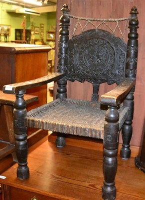 Lot 1340 - A carved oak throne chair