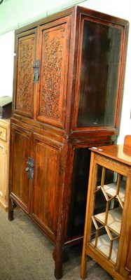 Lot 1346 - A carved Chinese cabinet with four panelled doors, the top doors decorated with flowers, first...