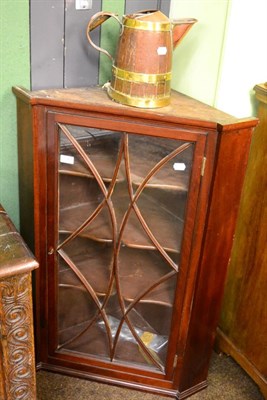 Lot 1361 - A 19th century mahogany hanging corner cupboard, a brass and copper coopered oak jug of similar age