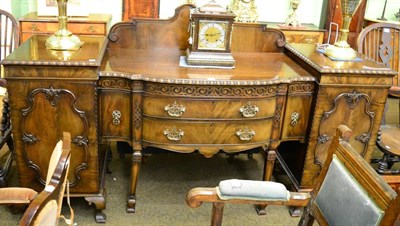 Lot 1364 - A Waring & Gillow pedestal sideboard with carved moulding and frieze, the bow fronted centre...