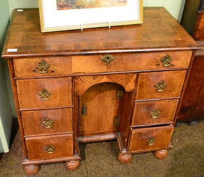 Lot 1375 - An 18th century style walnut kneehole desk