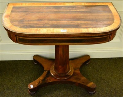 Lot 1379 - A 19th century rosewood foldover card table, crossbanded, raised on associated octagonal column...