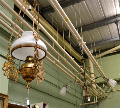 Lot 1387 - A late 19th/early 20th century brass chandelier with frosted shades and a gilt metal light...