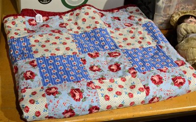 Lot 1416 - A 20th century American patchwork quilt, with squares of rose patterned fabrics and backed onto...