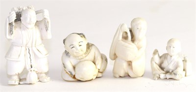 Lot 128 - Three early 20th century Japanese ivory netsukes and a similar okimono (4)