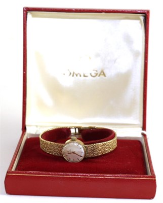 Lot 151 - A lady's 9ct gold wristwatch, signed Omega, with Omega box and booklets