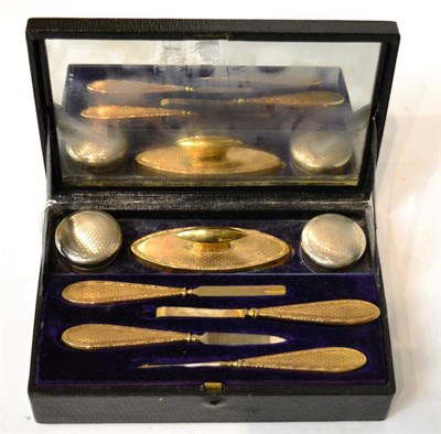 Lot 167 - A cased silver gilt handled manicure set