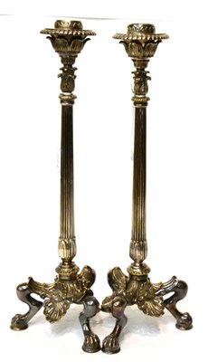 Lot 175 - A pair of late Victorian silver plated candlesticks, with leaf sheathed sockets, fluted...