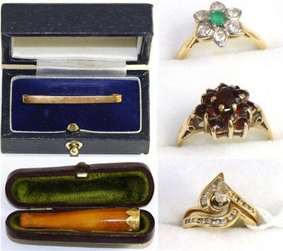 Lot 210 - A diamond cluster ring, an emerald and diamond cluster ring, a garnet cluster ring, a tie bar and a