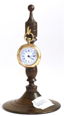 Lot 215 - A Continental lady's fob watch, the case stamped '14K', with rosewood stand