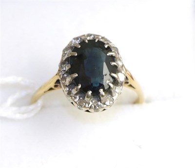 Lot 234 - A sapphire and diamond cluster ring, stamped '18ct', finger size L