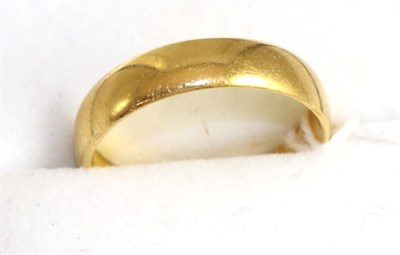 Lot 254 - A broad 22ct gold band ring