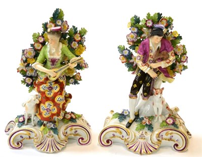 Lot 258 - A pair of Derby style figure groups of musicians, man playing bagpipes accompanied by dog and woman