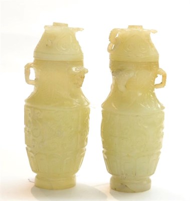 Lot 261 - Two Chinese miniature jade canisters and covers, 20th Century, 12cm in height (a.f.) (2)