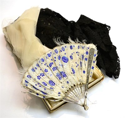 Lot 285 - A Chinese white metal fan with filigree sticks and embossed guards, with white feather mount...