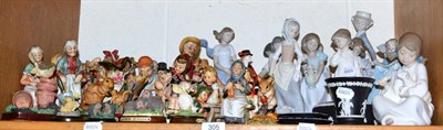 Lot 305 - A collection of Nao figure groups, two Lladro examples, Goebel figures, other German and...