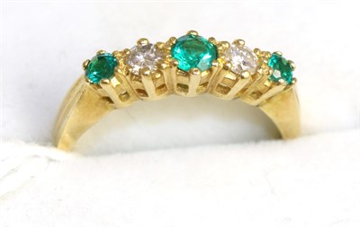 Lot 405 - An 18ct gold emerald and diamond ring, total estimated diamond weight 0.20 carat approximately,...