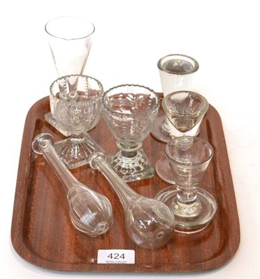 Lot 424 - A tray of 18th and 19th century glass including two toddy lifters, a deception glass, a firing...