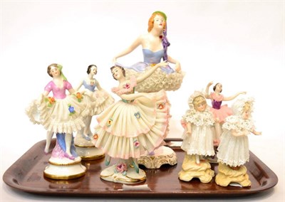 Lot 437 - A collection of Dresden ballerina and children figures, typically intricately decorated;...