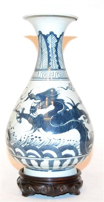 Lot 459 - A Chinese porcelain bottle vase, underglaze dragon chasing flaming pearl, six character marks...