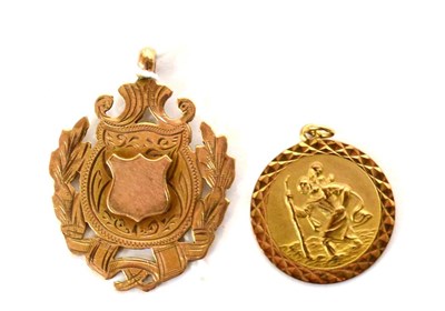 Lot 549 - A 9ct gold sporting medallion and a 9ct gold St. Christopher pendant (2)