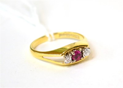 Lot 552 - An 18ct gold ruby and diamond ring three stone ring, total estimated diamond weight 0.10 carat...