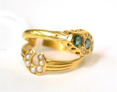 Lot 573 - An 18ct gold seed pearl set horseshoe ring, finger size O and an emerald and diamond ring,...