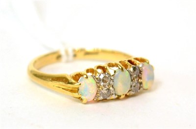 Lot 574 - An opal and diamond ring, finger size O1/2