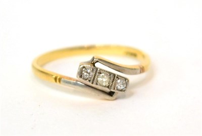 Lot 579 - A 9ct gold three stone diamond crossover ring