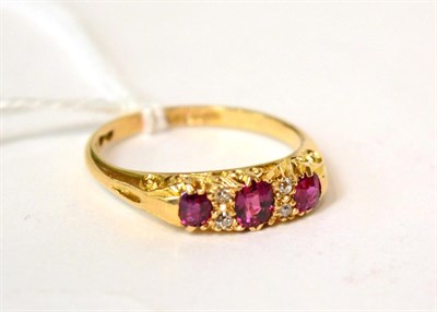 Lot 588 - An 18ct gold ruby and diamond ring, finger size Q