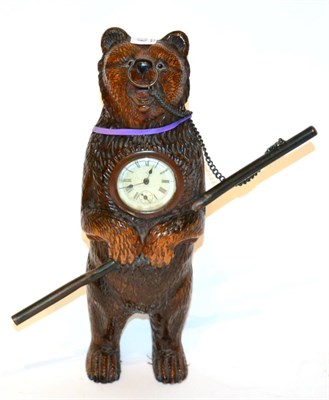 Lot 602 - A black forest carved bear clock