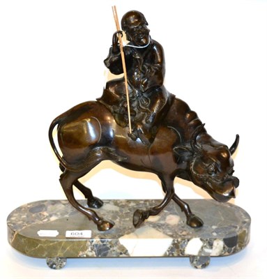 Lot 604 - A Chinese bronze of a boy seated upon a water buffalo, marble base, 40cm in height