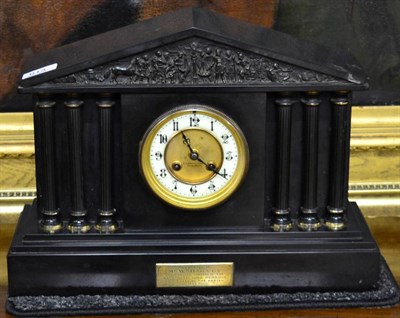 Lot 613 - A black slate striking mantel clock